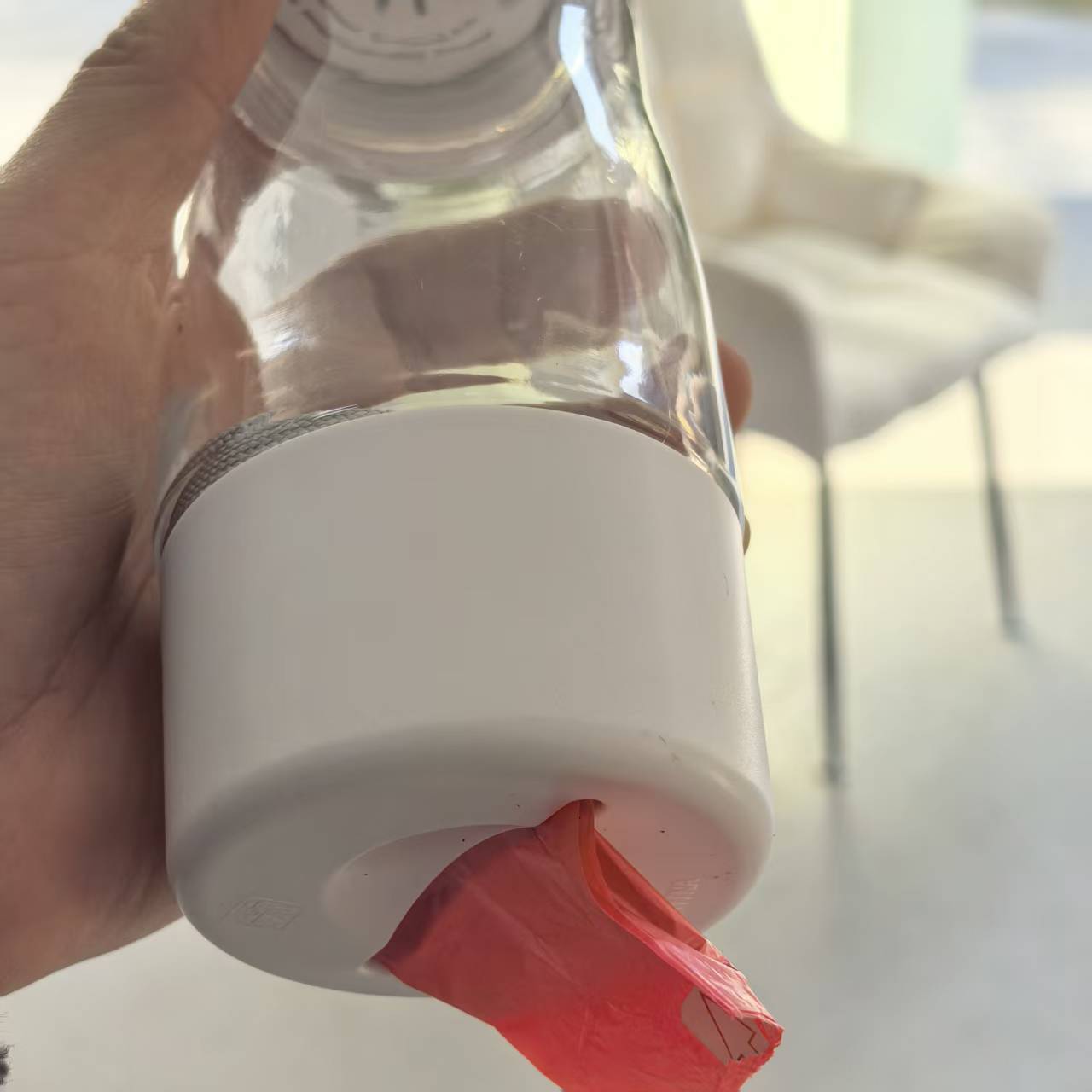 3-in-1 pet travel cup showing water dispenser, food storage, and trash bag holder