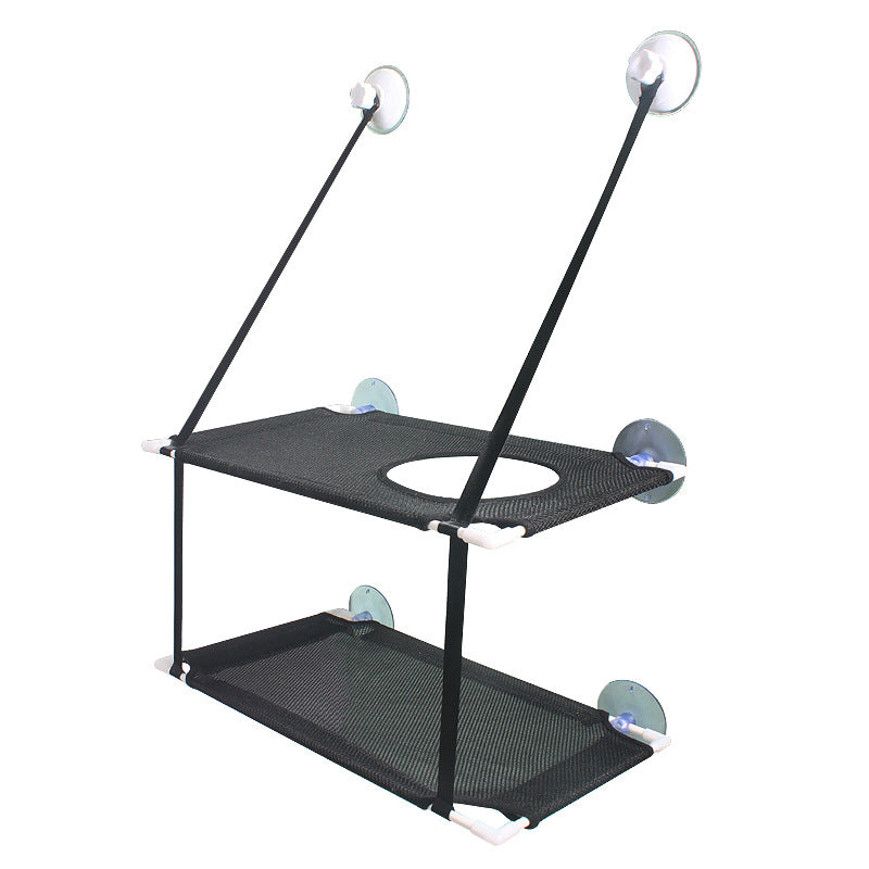 Cat lounging on breathable mesh window hammock in sunlight