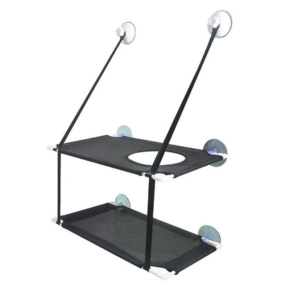 Cat lounging on breathable mesh window hammock in sunlight