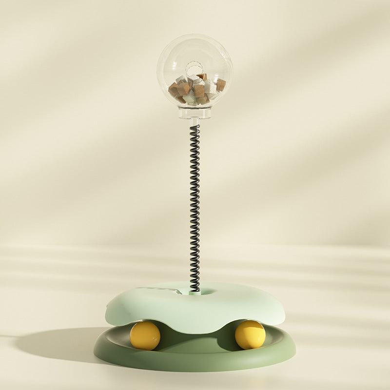 Green SpringSnack treat dispensing spring toy for cats and small pets — side view showing turntable ball


