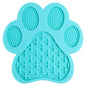 Sky blue LickEase silicone lick mat for dogs — suction base on tile floor during bath time

